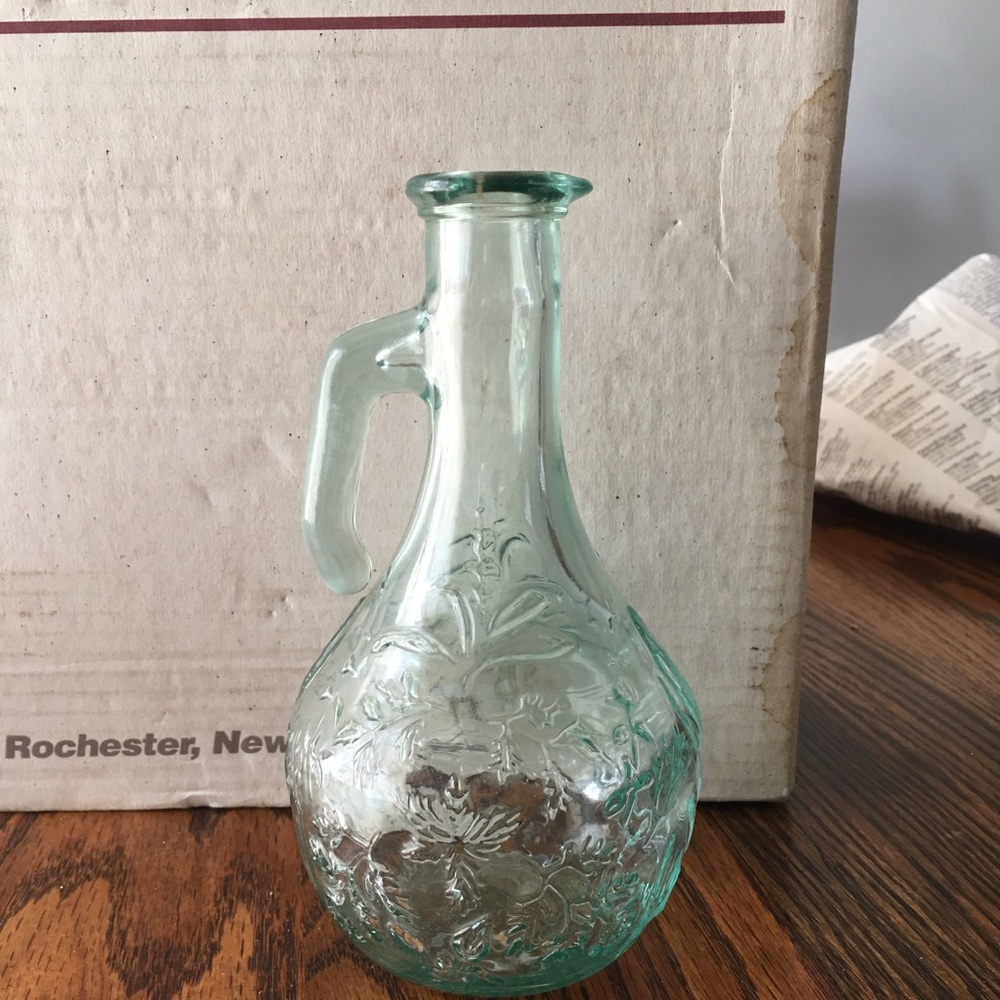Green tinted glass pitcher with leaf design. Stamped Canada. Missing cork